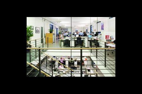 A central stairwell connects the ground floor and basement of the London office.